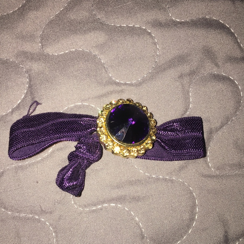 Purple ribbon bracelet.